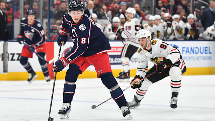 Blue Jackets defenseman Zach Werenski moves the puck ahead of Chicago forward Frank Nazar.