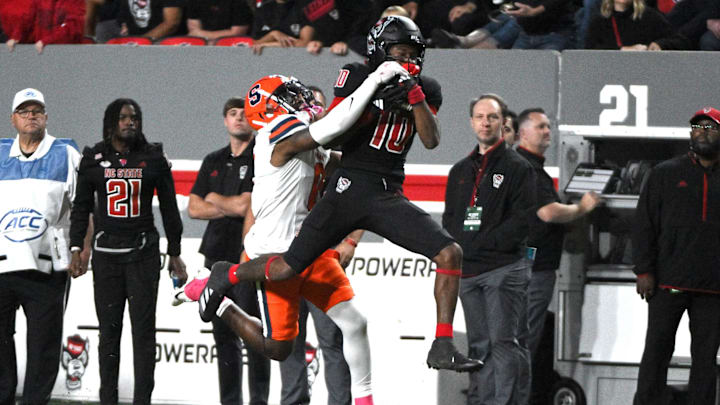 Oct 12, 2024; Raleigh, North Carolina, USA; North Carolina State Wolfpack linebacker Caden Fordham (10) catches pass while under pressure from Syracuse Orange defensive back Duce Chestnut (0) at Carter-Finley Stadium. Mandatory Credit: Zachary Taft-Imagn Images Oct 12, 2024; Raleigh, North Carolina, USA; North Carolina State Wolfpack linebacker Caden Fordham (10) catches pass while under pressure from Syracuse Orange defensive back Duce Chestnut (0) at Carter-Finley Stadium. Mandatory Credit: Zachary Taft-Imagn Images