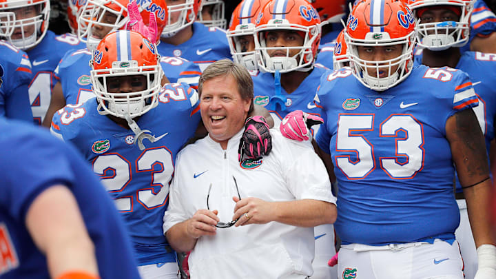 Oct 28, 2017; Jacksonville, FL, USA;Florida Gators head coach Jim McElwain gets pumped up with defensive back Chauncey Gardner Jr. (23) and offensive lineman Kavaris Harkless (53) before the game against the Georgia Bulldogs at EverBank Field. Mandatory Credit: Kim Klement-Imagn Images