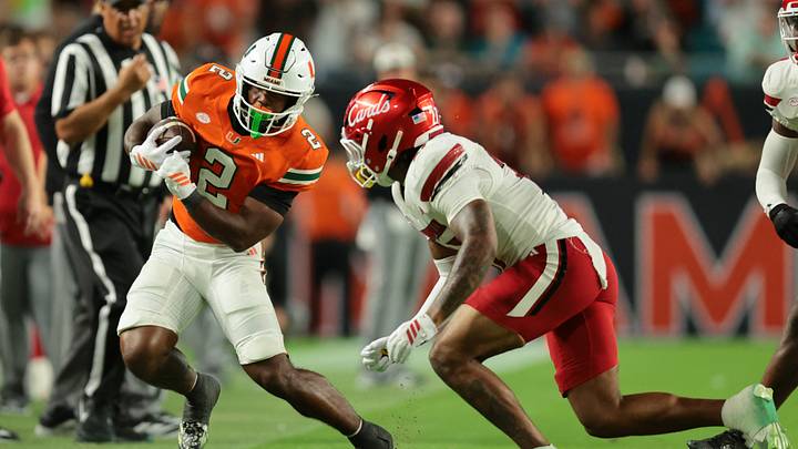 Oct 17, 2025; Miami Gardens, Florida, USA; Miami Hurricanes running back Jordan Lyle (2) runs out of bounds as Louisville Cardinals defensive back Jojo Evans Jr. (27) defends during the fourth quarter at Hard Rock Stadium. Mandatory Credit: Sam Navarro-Imagn Images Oct 17, 2025; Miami Gardens, Florida, USA; Miami Hurricanes running back Jordan Lyle (2) runs out of bounds as Louisville Cardinals defensive back Jojo Evans Jr. (27) defends during the fourth quarter at Hard Rock Stadium. Mandatory Credit: Sam Navarro-Imagn Images