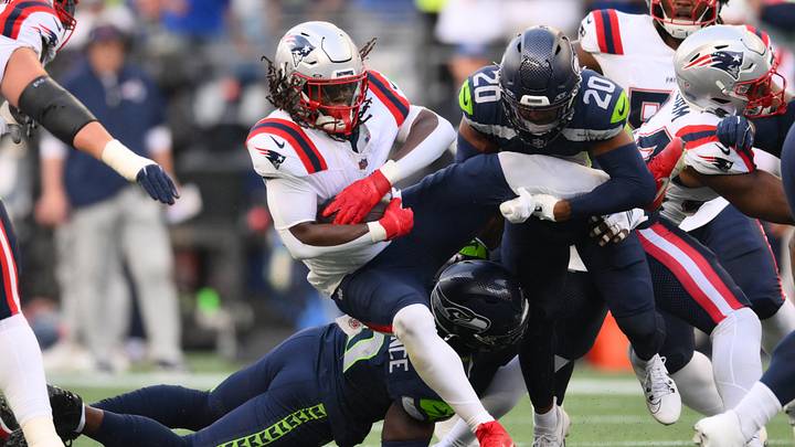 Sep 9, 2026; Seattle, Washington, USA; Seattle Seahawks safety Julian Love (20) tackles New England Patriots running back Rhamondre Stevenson (38) during the first quarter at Lumen Field. Mandatory Credit: Steven Bisig-Imagn Images Sep 9, 2026; Seattle, Washington, USA; Seattle Seahawks safety Julian Love (20) tackles New England Patriots running back Rhamondre Stevenson (38) during the first quarter at Lumen Field. Mandatory Credit: Steven Bisig-Imagn Images