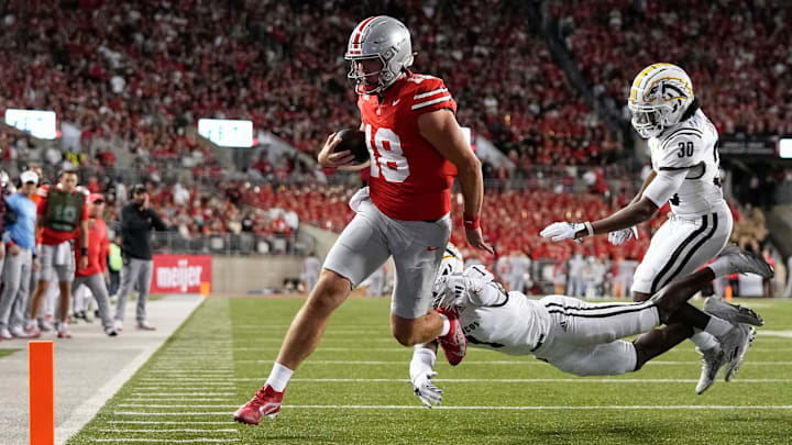 Sep 7, 2024; Columbus, Ohio, USA; Ohio State Buckeyes quarterback Will Howard (18) runs for a touchdown past Western Michigan Broncos cornerback Bilhal Kone (1) and safety Armani-Eli Adams (30) during the first half of the NCAA football game at Ohio Stadium.