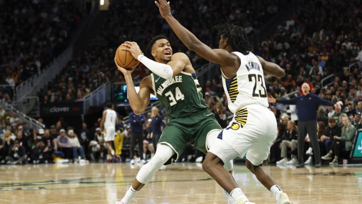Jan 1, 2024; Milwaukee, Wisconsin, USA; Milwaukee Bucks forward Giannis Antetokounmpo (34) is defended by Indiana Pacers forward Aaron Nesmith (23). Jan 1, 2024; Milwaukee, Wisconsin, USA; Milwaukee Bucks forward Giannis Antetokounmpo (34) is defended by Indiana Pacers forward Aaron Nesmith (23).