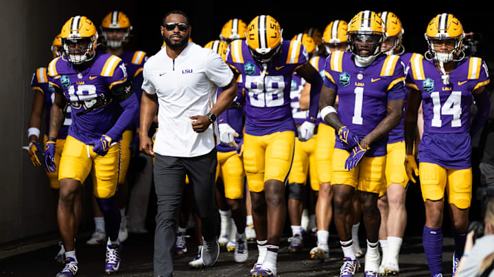 Jan 1, 2024; Tampa, FL, USA; LSU Tigers wide receivers coach Cortez Hankton, tight end Ka'Morreun Pimpton (88), and wide receiver Aaron Anderson (1) run onto the field before the game against the Wisconsin Badgers at Raymond James Stadium. Mandatory Credit: Matt Pendleton-Imagn Images Jan 1, 2024; Tampa, FL, USA; LSU Tigers wide receivers coach Cortez Hankton, tight end Ka'Morreun Pimpton (88), and wide receiver Aaron Anderson (1) run onto the field before the game against the Wisconsin Badgers at Raymond James Stadium. Mandatory Credit: Matt Pendleton-Imagn Images
