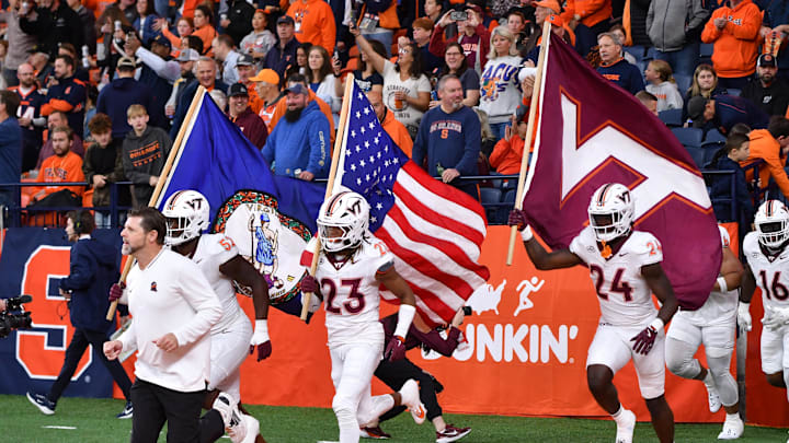 Nov 2, 2024; Syracuse, New York, USA; Virginia Tech Hokies cornerback Thomas Williams (23) carries the American flag onto the field with his team before a game against the Syracuse Orange at JMA Wireless Dome. Mandatory Credit: Mark Konezny-Imagn Images Nov 2, 2024; Syracuse, New York, USA; Virginia Tech Hokies cornerback Thomas Williams (23) carries the American flag onto the field with his team before a game against the Syracuse Orange at JMA Wireless Dome. Mandatory Credit: Mark Konezny-Imagn Images