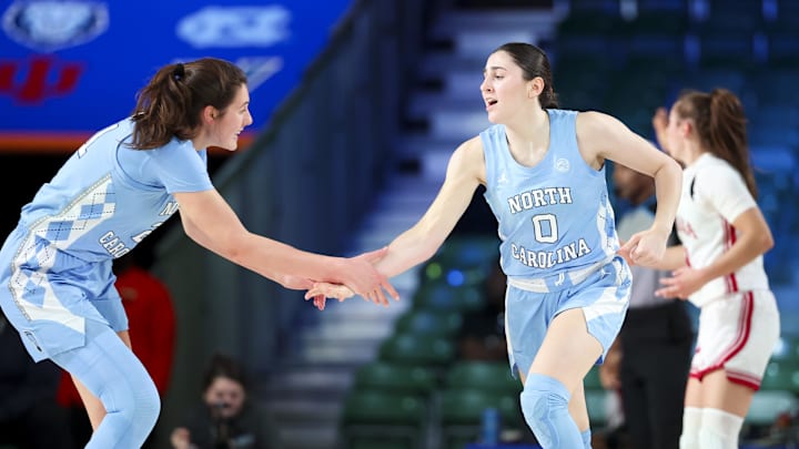 Nov 25, 2024; Paradise Island, Bahamas, BHS; North Carolina Tar Heels guard Lanie Grant (0) celebrates with North Carolina Tar Heels forward Ciera Toomey (21) after scoring during the first half against the Indiana Hoosiers at the Atlantis Resort. Mandatory Credit: Kevin Jairaj-Imagn Images