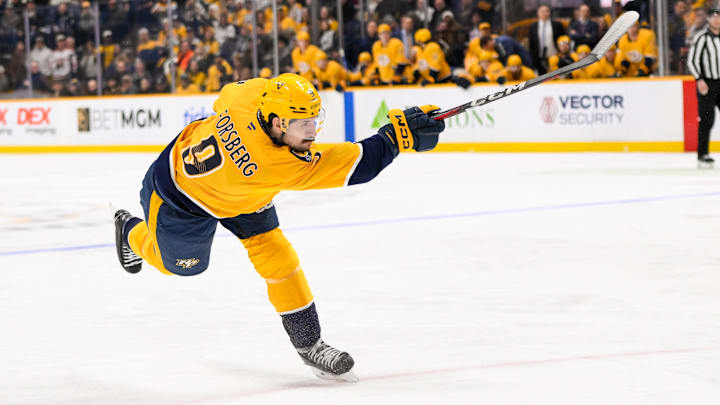 Jan 21, 2025; Nashville, Tennessee, USA;  Nashville Predators left wing Filip Forsberg (9) takes a shot on goal against the San Jose Sharks during the third period at Bridgestone Arena. Mandatory Credit: Steve Roberts-Imagn Images