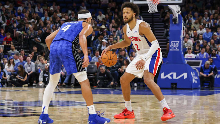 Detroit Pistons guard Cade Cunningham (2) handles the ball in front of Orlando Magic guard Jalen Suggs (4) during the second half at KIA Center. 