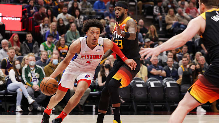 Jan 21, 2022; Salt Lake City, Utah, USA;  Detroit Pistons guard Cade Cunningham (2) dribbles around Utah Jazz forward Royce O'Neale (23) and goes to the basket during the first quarter at Vivint Arena. Mandatory Credit: Chris Nicoll-Imagn Images