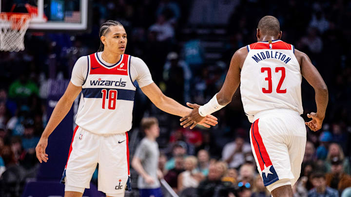 Mar 1, 2025; Charlotte, North Carolina, USA; Washington Wizards forward Kyshawn George (18) celebrates with forward Khris Middleton (32) during the third quarter against the Charlotte Hornets at Spectrum Center. Mandatory Credit: Scott Kinser-Imagn Images