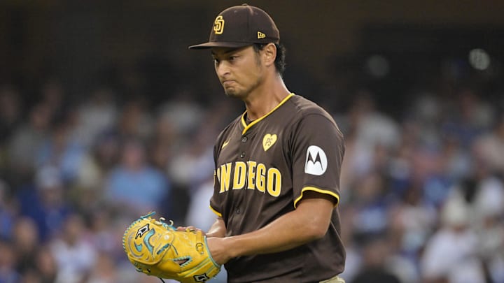 Oct 11, 2024; Los Angeles, California, USA; San Diego Padres pitcher Yu Darvish (11) reacts in the fourth inning against the Los Angeles Dodgers during game five of the NLDS for the 2024 MLB Playoffs at Dodger Stadium. Mandatory Credit: Jayne Kamin-Oncea-Imagn Images