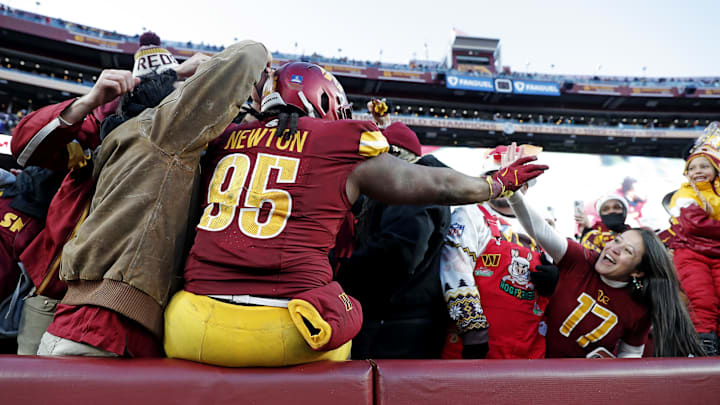 Washington Commanders defensive tackle Newton jumps into the stands to celebrates with fans after the Washington Commanders beat the Philadelphia Eagles. Washington Commanders defensive tackle Newton jumps into the stands to celebrates with fans after the Washington Commanders beat the Philadelphia Eagles.