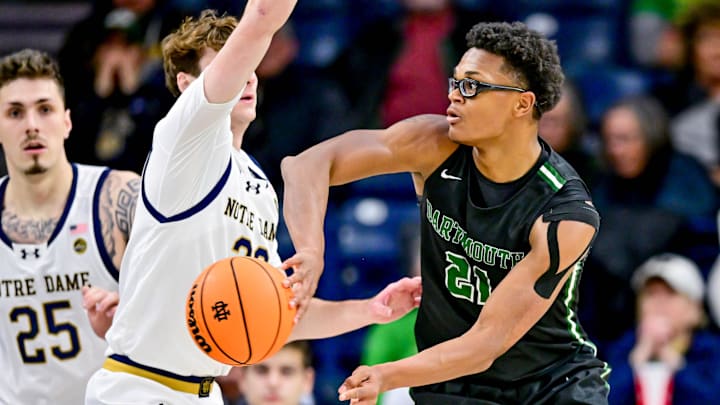 Dec 11, 2024; South Bend, Indiana, USA; Dartmouth Big Green forward Brandon Mitchell-Day (21) passes around Notre Dame Fighting Irish guard J.R. Konieczny (20) in the first half at the Purcell Pavilion.
