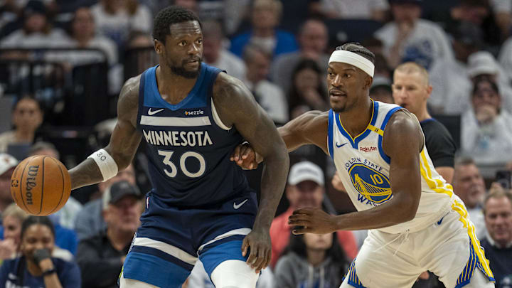May 8, 2025; Minneapolis, Minnesota, USA; Minnesota Timberwolves forward Julius Randle (30) backs towards the basket as Golden State Warriors forward Jimmy Butler III (10) plays defense in the second half during game two of the second round for the 2025 NBA Playoffs at Target Center.