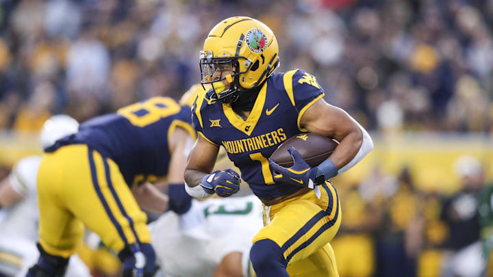 Nov 16, 2024; Morgantown, West Virginia, USA; West Virginia Mountaineers running back Jahiem White (1) runs the ball during the first quarter against the Baylor Bears at Mountaineer Field at Milan Puskar Stadium. Mandatory Credit: Ben Queen-Imagn Images
