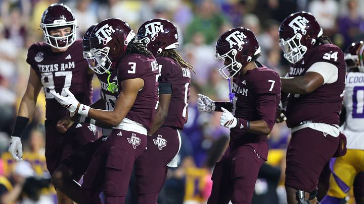 Oct 25, 2025; Baton Rouge, Louisiana, USA; Texas A&M Aggies quarterback Marcel Reed (10) celebrates with teammates after a touchdown during the first half against the Louisiana State Tigers at Tiger Stadium. Mandatory Credit: Stephen Lew-Imagn Images Oct 25, 2025; Baton Rouge, Louisiana, USA; Texas A&M Aggies quarterback Marcel Reed (10) celebrates with teammates after a touchdown during the first half against the Louisiana State Tigers at Tiger Stadium. Mandatory Credit: Stephen Lew-Imagn Images