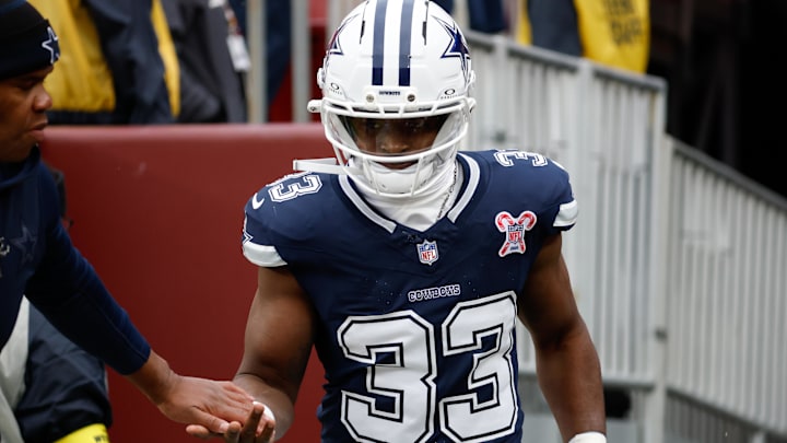Dallas Cowboys running back Javonte Williams runs onto the field before the game against the Washington Commanders 