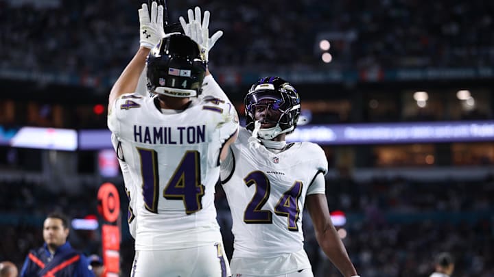 Oct 30, 2025; Miami Gardens, Florida, USA;  Baltimore Ravens safety Kyle Hamilton (14) and safety Malaki Starks (24) react after a play during the second quarter against the Miami Dolphins at Hard Rock Stadium. Mandatory Credit: Nathan Ray Seebeck-Imagn Images