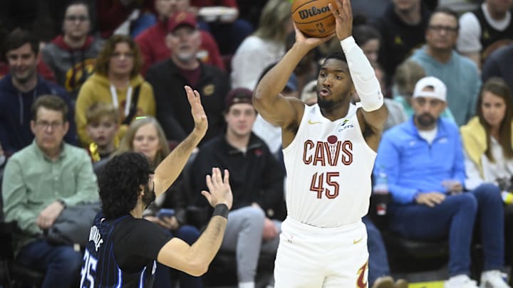 Mar 16, 2025; Cleveland, Ohio, USA; Cleveland Cavaliers guard Donovan Mitchell (45) shoots beside Orlando Magic center Goga Bitadze (35) in the fourth quarter at Rocket Arena. Mandatory Credit: David Richard-Imagn Images