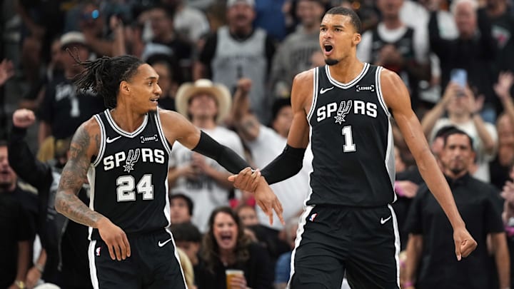 May 12, 2026; San Antonio, Texas, USA; San Antonio Spurs forward Victor Wembanyama and guard Devin Vassell (24) react during the first half of game five of the second round of the 2026 NBA Playoffs against the Minnesota Timberwolves at Frost Bank Center. Mandatory Credit: Scott Wachter-Imagn Images