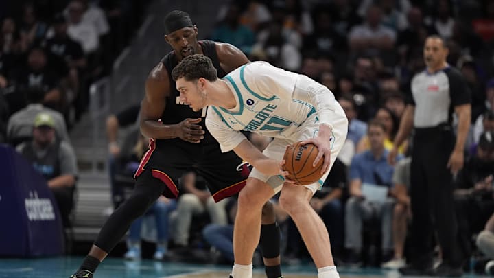 Apr 14, 2026; Charlotte, North Carolina, USA; Charlotte Hornets center Ryan Kalkbrenner (11) handles the ball guarded by Miami Heat center/forward Bam Adebayo (13) during the second quarter during the play-in rounds between the Charlotte Hornets and the Miami Heat of the 2026 NBA Playoffs at Spectrum Center. Apr 14, 2026; Charlotte, North Carolina, USA; Charlotte Hornets center Ryan Kalkbrenner (11) handles the ball guarded by Miami Heat center/forward Bam Adebayo (13) during the second quarter during the play-in rounds between the Charlotte Hornets and the Miami Heat of the 2026 NBA Playoffs at Spectrum Center.