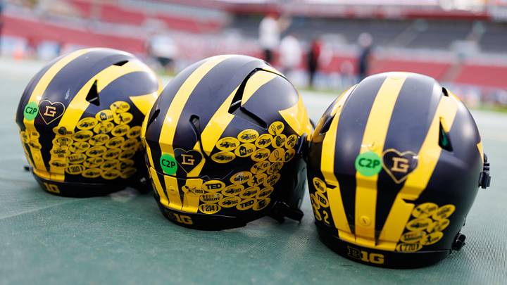 Dec 31, 2024; Tampa, FL, USA; Michigan Wolverines quarterback helmets sit on the field before a game against the Alabama Crimson Tide at Raymond James Stadium. Mandatory Credit: Matt Pendleton-Imagn Images Dec 31, 2024; Tampa, FL, USA; Michigan Wolverines quarterback helmets sit on the field before a game against the Alabama Crimson Tide at Raymond James Stadium. Mandatory Credit: Matt Pendleton-Imagn Images
