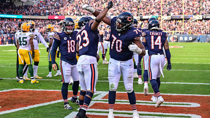 Roschon Johnson celebrates a touchdown with Braxton Jones against Green Bay. Johnson leads the Bears in rushing TDs with six.