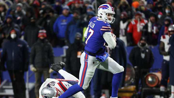 Bills quarterback Josh Allen escapes a tackle by Patriots Christian Baremore.