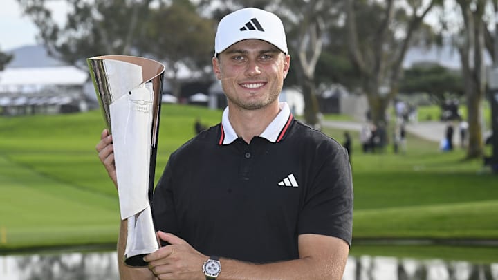 Feb 16, 2025; San Diego, California, USA; Ludvig Aberg holds up the trophy after winning The Genesis Invitational golf tournament at Torrey Pines. Mandatory Credit: Denis Poroy-Imagn Images