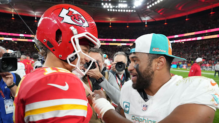 Kansas City Chiefs quarterback Patrick Mahomes (15) and Miami Dolphins quarterback Tua Tagovailoa (1) shake hands after an NFL International Series game at Deutsche Bank Park in 2023.