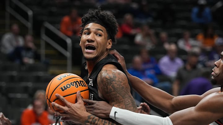 Bearcats Dillon Mitchell (23) looks for a pass during Game 1 of the 2025 Phillips 66 Big 12 Basketball Championship against the Oklahoma State Cowboys at the T-Mobile Center in Kansas City, Missouri on Tuesday March 11, 2025. Bearcats lead the game at halftime with a score of 38-26.