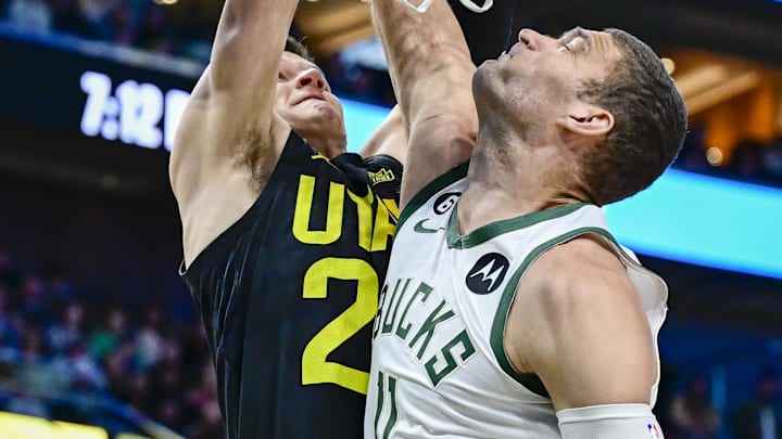 Mar 24, 2023; Salt Lake City, Utah, USA; Utah Jazz center Walker Kessler (24) takes a shot over Milwaukee Bucks center Brook Lopez (11) during the first half at Vivint Arena. Mandatory Credit: Christopher Creveling-Imagn Images