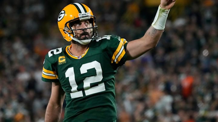 Green Bay Packers quarterback Aaron Rodgers (12) celebrates after rushing for a first down during