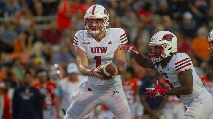 UIWs' Zach Calzada (1) hands the ball to Jarrel Wiley (5) against UTEP on Sep. 2, 2023