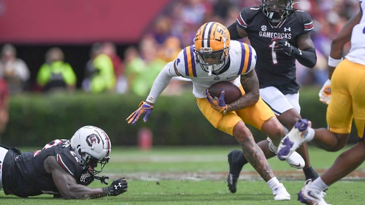 Sep 14, 2024; Columbia, South Carolina, USA; LSU Tigers CJ Daniels (4) runs against South Carolina Gamecocks linebacker Bam Martin-Scott (22) during the second quarter at Williams-Brice Stadium. Mandatory Credit: Ken Ruinard/USA TODAY Network via Imagn Images Sep 14, 2024; Columbia, South Carolina, USA; LSU Tigers CJ Daniels (4) runs against South Carolina Gamecocks linebacker Bam Martin-Scott (22) during the second quarter at Williams-Brice Stadium. Mandatory Credit: Ken Ruinard/USA TODAY Network via Imagn Images
