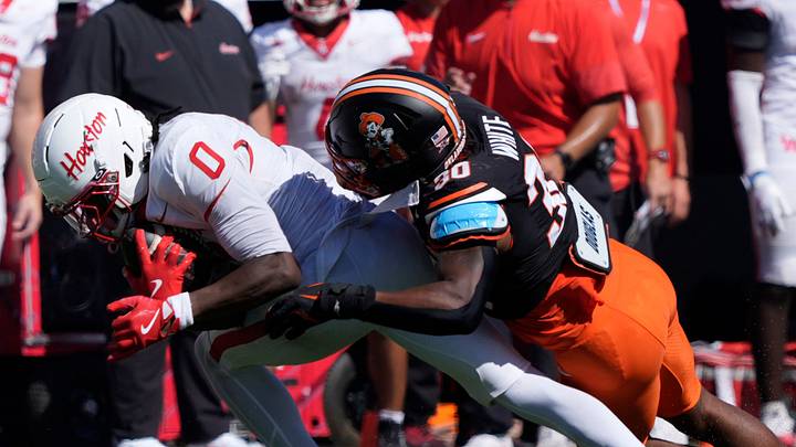 Oklahoma State Cowboys linebacker Trip White (30) brings down Houston Cougars wide receiver Amare Thomas (0) during a college football game between the Oklahoma State Cowboys (OSU) and the Houston Cougars at Boone Pickens Stadium in Stillwater, Okla., Saturday, Oct. 11, 2025. Houston won 39-17. Oklahoma State Cowboys linebacker Trip White (30) brings down Houston Cougars wide receiver Amare Thomas (0) during a college football game between the Oklahoma State Cowboys (OSU) and the Houston Cougars at Boone Pickens Stadium in Stillwater, Okla., Saturday, Oct. 11, 2025. Houston won 39-17.