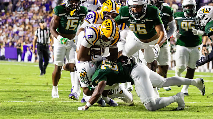 Sep 20, 2025; Baton Rouge, Louisiana, USA;  LSU Tigers quarterback Ju’Juan Johnson (8) is tackled by Southeastern Louisiana Lions during the first half at Tiger Stadium. Mandatory Credit: Stephen Lew-Imagn Images