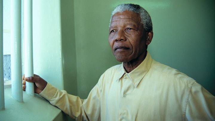 Nelson Mandela revisiting the cell at Robben Island prison where he was jailed for 27 years.