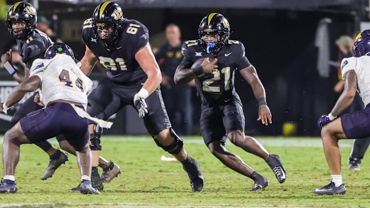 Sep 6, 2025; Orlando, Florida, USA; UCF Knights running back Stacy Gage (21) runs the ball during the second half against the North Carolina A&T Aggies at Acrisure Bounce House. Mandatory Credit: Mike Watters-Imagn Images