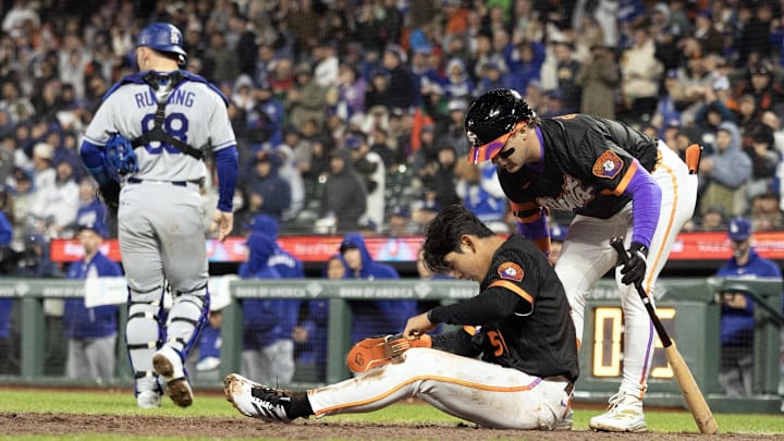 Apr 21, 2026; San Francisco, California, USA; San Francisco Giants center fielder Drew Gilbert (0) helps up teammate Jung Hoo Lee (51) after he was thrown out at home trying to score against the Los Angeles Dodgers during the sixth inning at Oracle Park. Mandatory Credit: D. Ross Cameron-Imagn Images