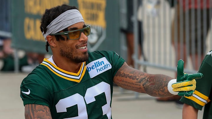 Green Bay Packers cornerback Jaire Alexander gestures to the crowd as he rides a bicycle in the DreamDrive before practice.