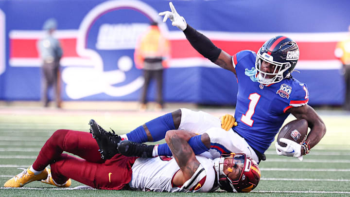 Nov 3, 2024; East Rutherford, New Jersey, USA; New York Giants wide receiver Malik Nabers (1) fights for a first down after a catch as Washington Commanders cornerback Benjamin St-Juste (25) tackles at MetLife Stadium.  