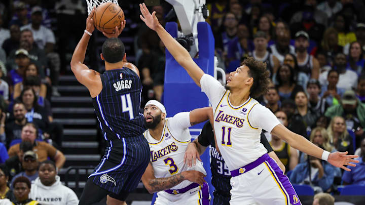 Nov 4, 2023; Orlando, Florida, USA; Orlando Magic guard Jalen Suggs (4) shoots the ball against Los Angeles Lakers forward Anthony Davis (3) and center Jaxson Hayes (11) during the first quarter at Amway Center. Mandatory Credit: Mike Watters-Imagn Images