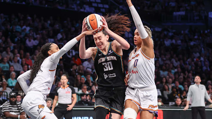 Sep 17, 2025; Brooklyn, New York, USA; New York Liberty forward Breanna Stewart (30) looks to drive past Phoenix Mercury forwards DeWanna Bonner (14) and Satou Sabally (0) during game two of round one for the 2025 WNBA Playoffs at Barclays Center. Mandatory Credit: Wendell Cruz-Imagn Images