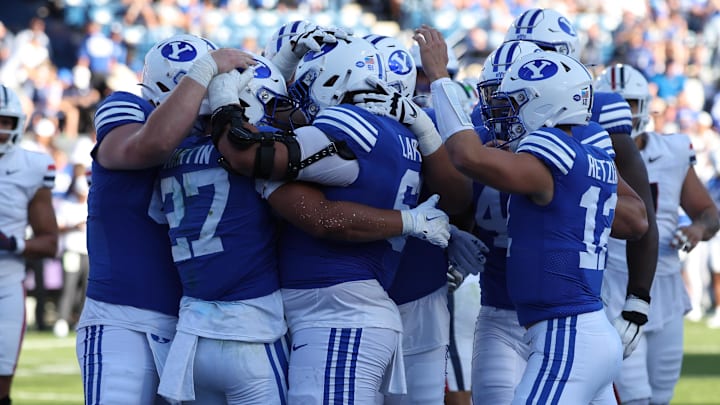Oct 12, 2024; Provo, Utah, USA; The Brigham Young Cougars celebrate a touchdown by running back LJ Martin (27) against the Arizona Wildcats during the fourth quarter at LaVell Edwards Stadium. Mandatory Credit: Rob Gray-Imagn Images