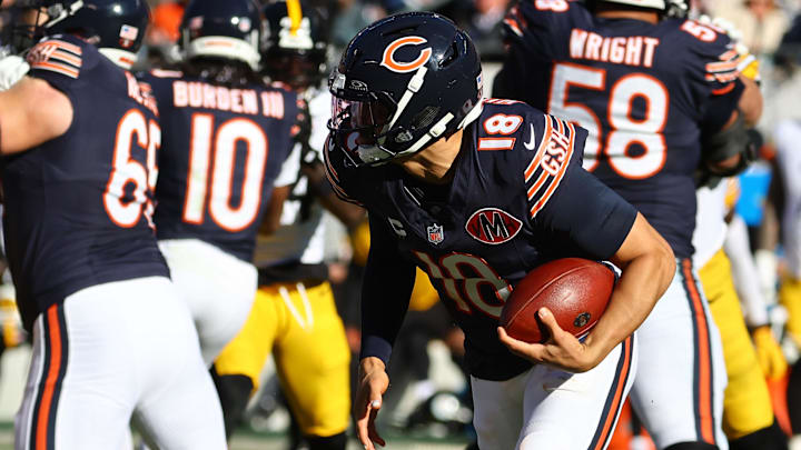 Nov 23, 2025; Chicago, Illinois, USA; Chicago Bears quarterback Caleb Williams (18) rushes the ball for a first down on fourth down during the second half at Soldier Field. Mandatory Credit: Mike Dinovo-Imagn Images