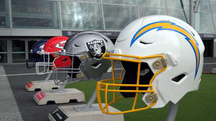 Oct 13, 2024; London, United Kingdom; Large helmets of the Los Angeles Chargers, Las Vegas Raiders, Kansas City Chiefs and Denver Broncos of the AFC West before an NFL International Series game at Tottenham Hotspur Stadium. Mandatory Credit: Kirby Lee-Imagn Images