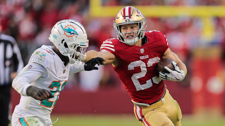 San Francisco 49ers running back Christian McCaffrey (23) stiff-arms Miami Dolphins cornerback Kader Kohou (28) during the fourth quarter at Levi's Stadium in a 2022 game.