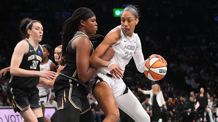 Sep 29, 2024; Brooklyn, New York, USA; Las Vegas Aces center A'ja Wilson (22) dribbles the ball against New York Liberty forward Jonquel Jones (35) during game one of the 2024 WNBA Semi-finals at Barclays Center. Mandatory Credit: Gregory Fisher-Imagn Images