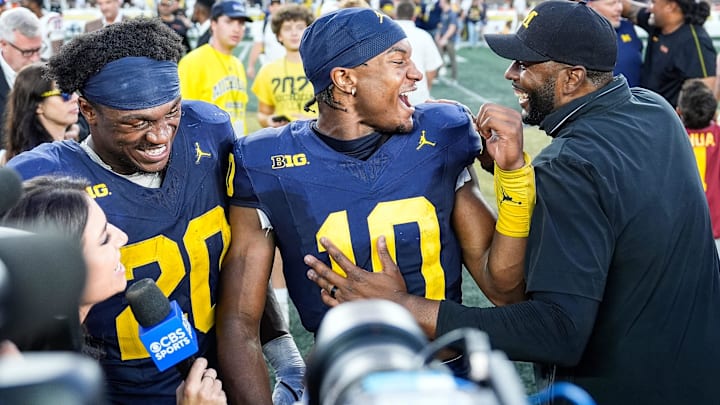 Alex Orji shares a moment with coach Sherrone Moore after a 27-24 win over USC at Michigan Stadium. Alex Orji shares a moment with coach Sherrone Moore after a 27-24 win over USC at Michigan Stadium.
